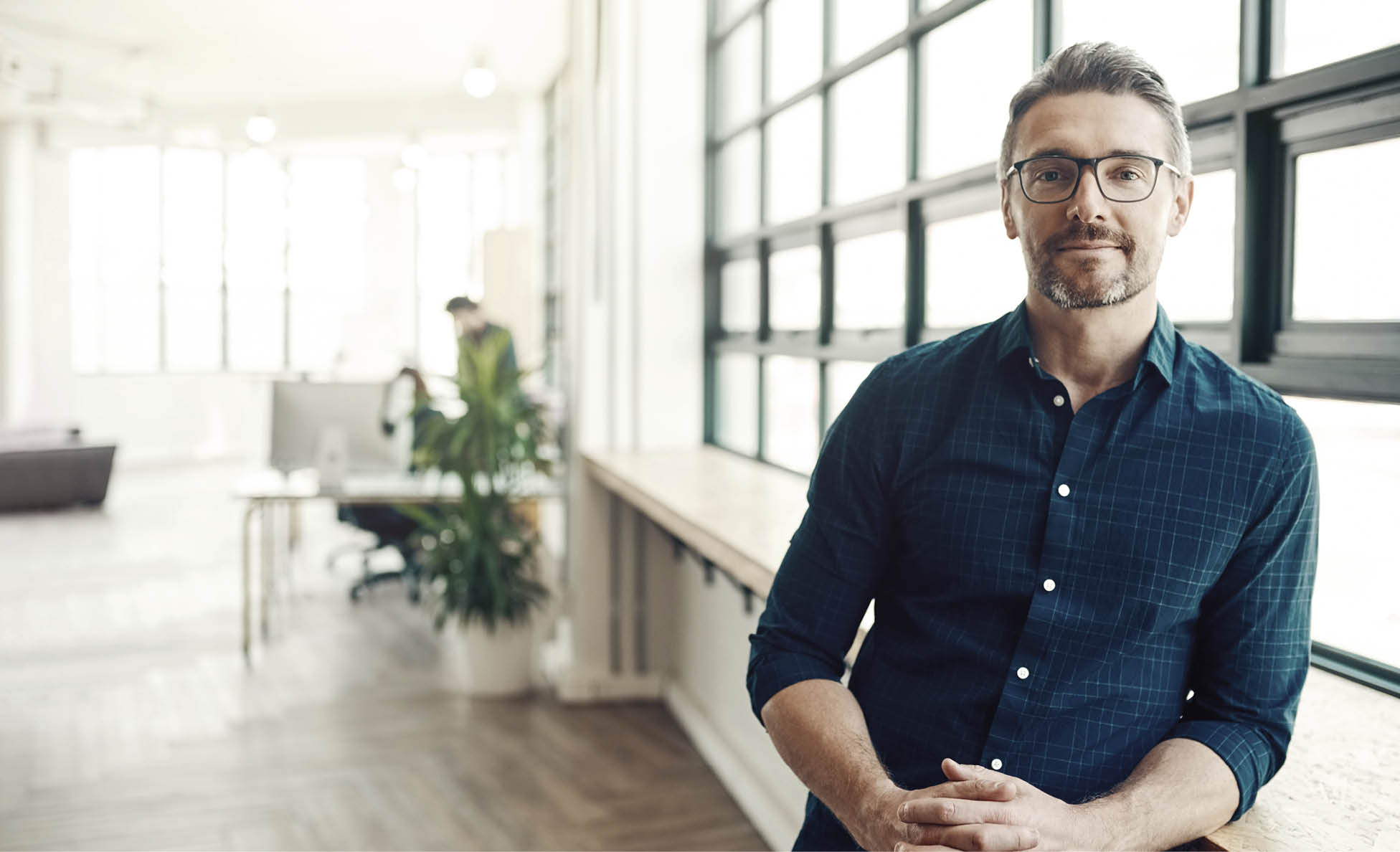 Portrait of a confident mature businessman working in a modern office
