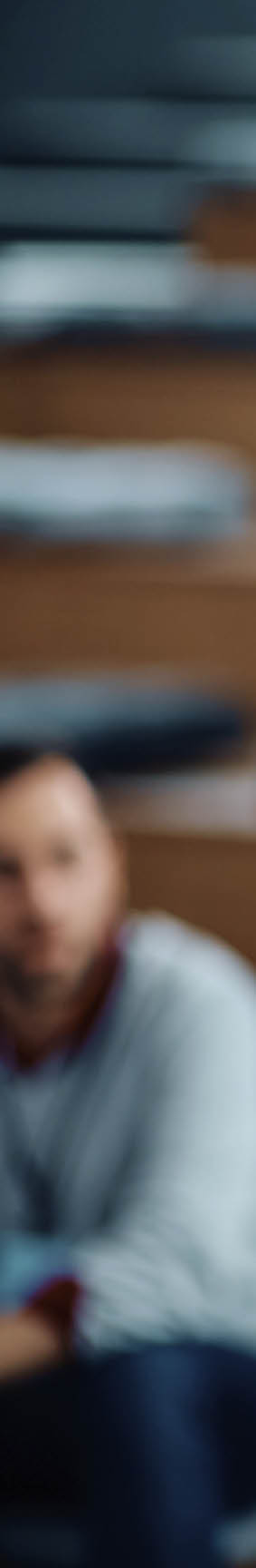 Mid adult businesswoman talking to group of seminar attendees in conference hall.